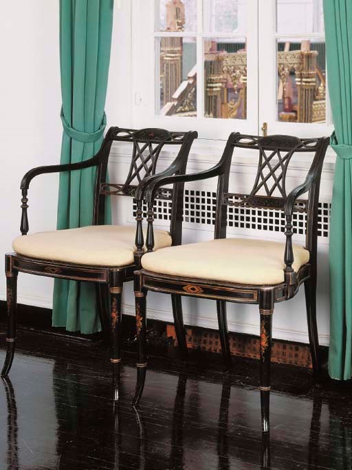 A PAIR OF REGENCY STYLE BLACK-PAINTED OPEN ARMCHAIRS