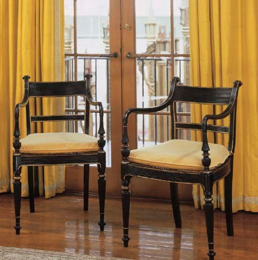A PAIR OF ANGLO-INDIAN EBONY AND PARCEL-GILT OPEN ARMCHAIRS