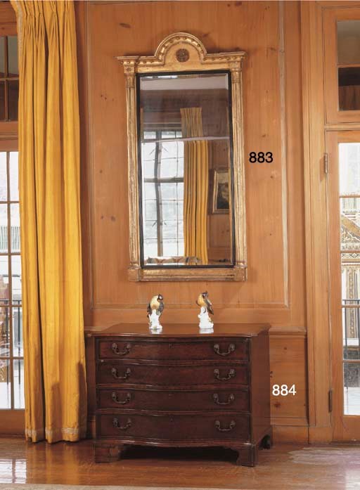 A GEORGE III MAHOGANY SERPENTINE CHEST-OF-DRAWERS