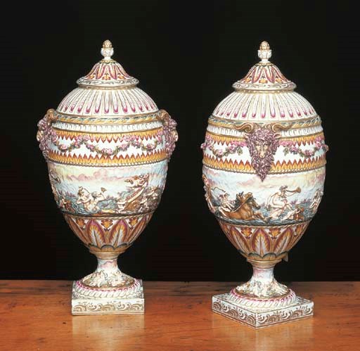A PAIR OF CONTINENTAL PORCELAIN CAPODIMONTE STYLE VASES AND COVERS