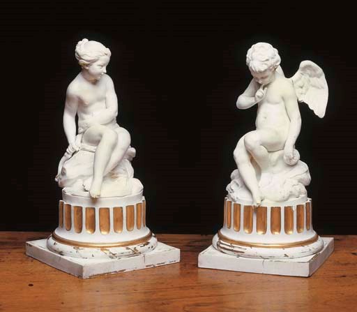 A PAIR OF SEVRES BISCUIT PORCELAIN FIGURES OF CUPID AND PSYCHE ON COLUMNAR BASES: 'L'AMOUR MENACANT' AND 'LA NYMPHE FALCONET'