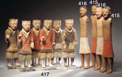 A pair of pottery stick figures