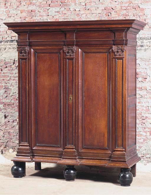 A BELGIAN OAK AND EBONISED ARMOIRE