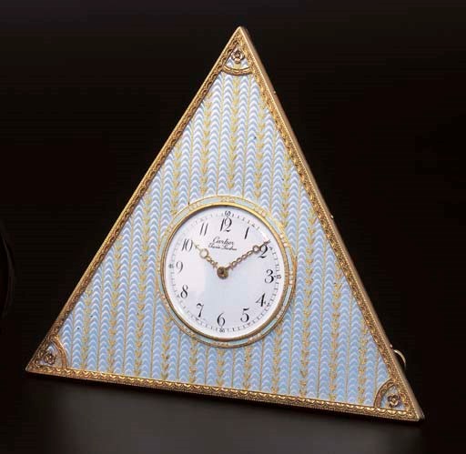 AN UNUSUAL TRIANGULAR TABLE CLOCK, BY CARTIER