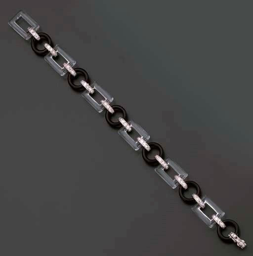 AN ART DECO DIAMOND, ONYX AND ROCK CRYSTAL BRACELET, BY CARTIER