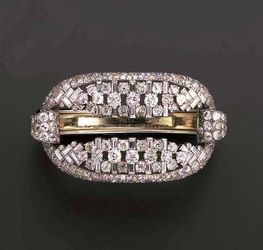 A DIAMOND AND BLACK ENAMEL BANGLE/BROOCH, BY CARTIER