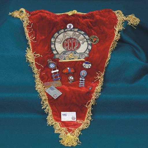 CCCP & UAMK - A decorative pennanthaving embroidered applied decorative design to front on a red velvet ground with cord attachment, and having competitors award lapel badges attached including UAMK, International Rallye Geneve, RAC with 'bars' for 1959, 1960, & 1961: Tulip Rally 1957 & 1958: International Rallye Sestriere 1960 & 1968: Mainz Automobile Club with 'bars' for 1960 & 1962: and Viking Rally with 'bars' for 1956, 1957, 1959 & 1960: and another.