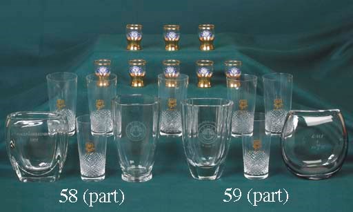 BP - Grand Prix International; A group of six cut glass crystal tumblers; having applied transfer chequered flag motif and International Grands Prix venues inscribed to front; together with Harrow Car Club, eight gilt embellished tot glasses, having applied motif design of the HCC sports car logo.                       (12)
