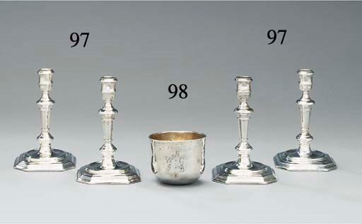 A set of four Queen Anne silver candlesticks