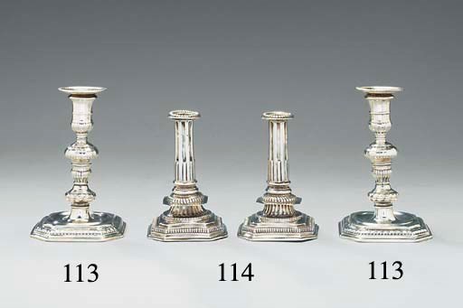 A pair of William III silver candlesticks