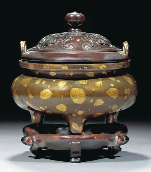 A bronze gold splashed tripod censer, 18th century