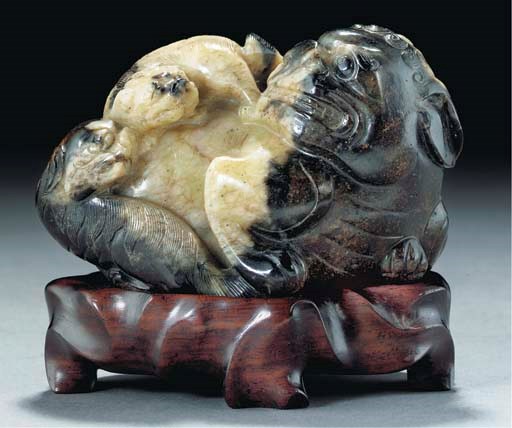 A mottled black and cream jade lion group, Ming Dynasty