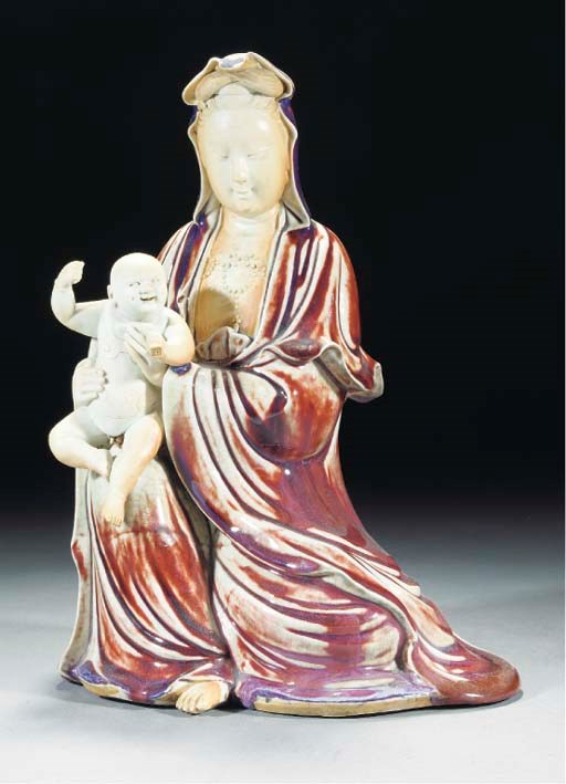 A biscuit and flambe glazed model of Guanyin, early 19th century