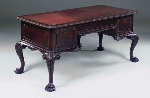 A CARVED MAHOGANY DESK