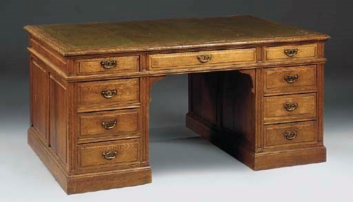 A LARGE OAK KNEEHOLE DESK