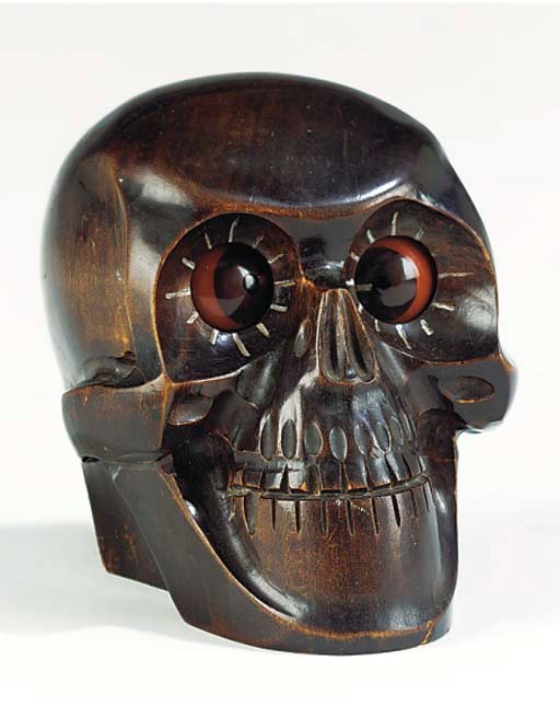 A German stained wood novelty revolving eye skull timepiece, circa 1930