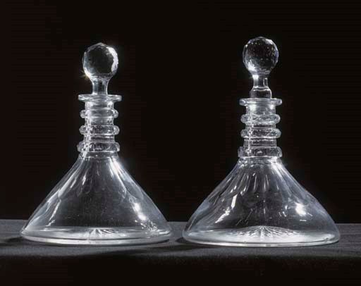 A PAIR OF SHIPS DECANTERS AND TWO ASSOCIATED STOPPERS