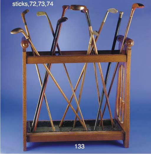 A LATE VICTORIAN OAK TRIPLE STICK STAND