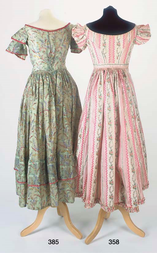 A lady's gown of striped pink and ivory silk, brocaded in coloured silks with bands of floral garlands, the boned bodice with low decolleté and short puffed sleeves, the full skirt open to the front and edged with ruched self-fabric trimming, 1820s