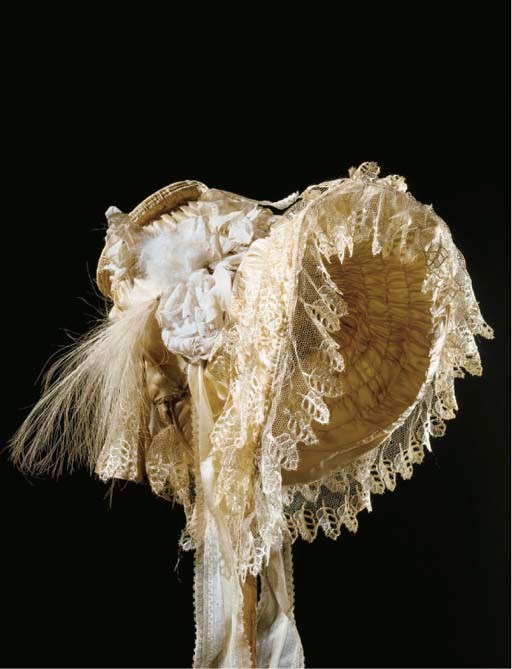 A lady's ivory satin bonnet, the front rim stiffened with self-fabric covered hooping to shaped crown, trimmed with Blonde lace, stiffened muslin floral motifs, striped ivory silk ribbons and feather detailing, circa 1830