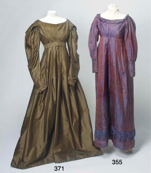 A lady's day dress of sage green silk, the high waisted bodice with pin-tucks and self-fabric panels from shoulders to waist-line, forming collar, lined with bottle green silk, with gigot sleeves, full skirt with padding to hem-line, lined with linen and glazed linen and matching belt, underarm staining and some damages, circa 1830