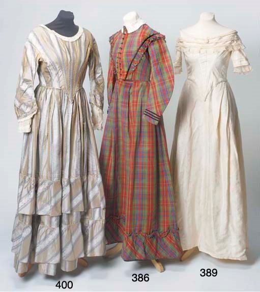 A lady's dress of red, green and blue wool plaid, the high-necked buttoned bodice with a self-fabric ruffle and black velvet ribbon trim running from shoulder to waist in a deep V, the full skirt trimmed with a ruffled flounce, with fine whitework embroidered collar, mid 19th century