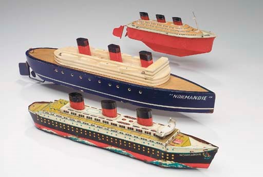 A wooden toy model, and two tin toy models of the S.S. Normandie