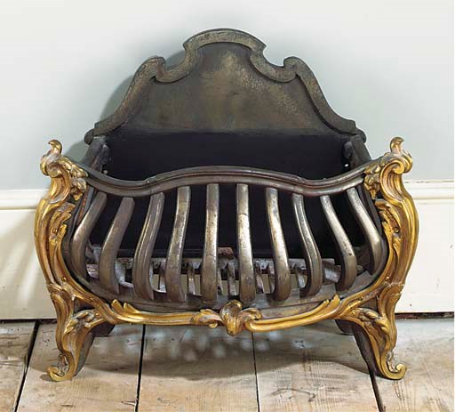 A CAST IRON AND BRASS MOUNTED FIREGRATE