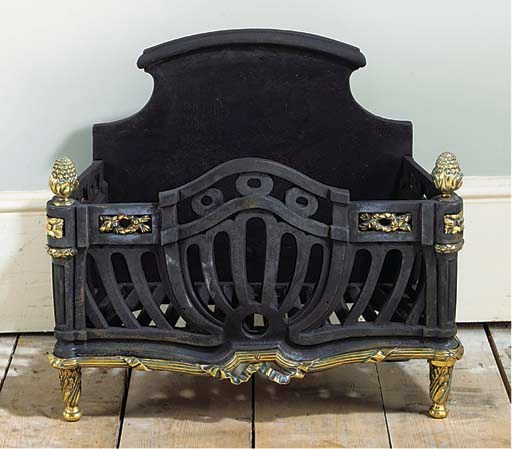 AN ENGLISH CAST IRON AND BRASS FIREGRATE