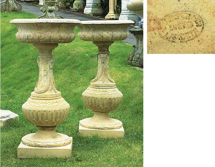 A PAIR OF ENGLISH TERRACOTTA URNS ON PEDESTALS