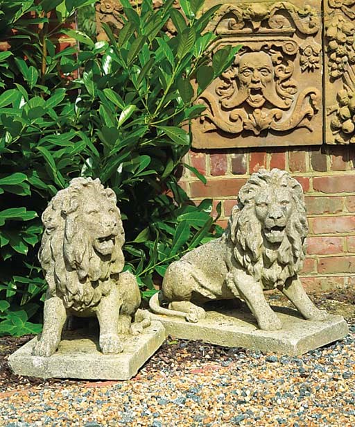 A PAIR OF ENGLISH ARTIFICIAL STONE MODELS OF LIONS