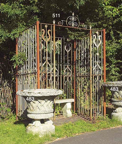 A PAIR OF LARGE COMPOSITE STONE BASKET URNS