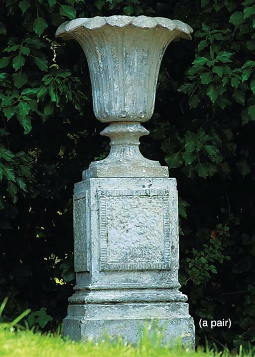 A PAIR OF ENGLISH ARTIFICIAL STONE URNS ON PEDESTALS