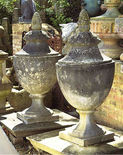 A PAIR OF COMPOSITE STONE OVOID URN FINIALS