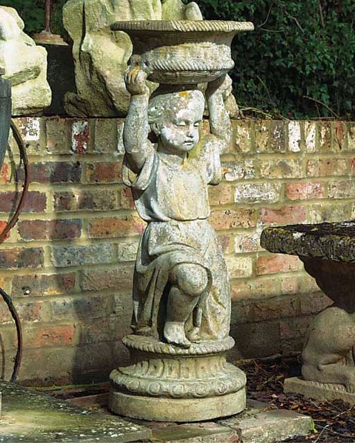 AN ENGLISH ARTIFICIAL STONE FIGURE OF A CHILD HOLDING ALOFT A BOWL