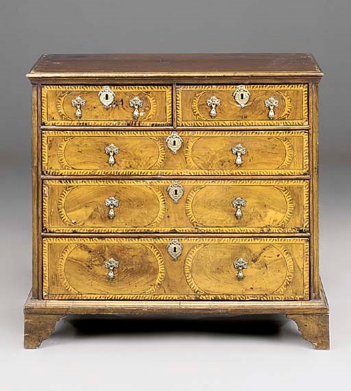A WALNUT AND MARQUETRY CHEST OF DRAWERS