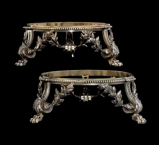 A SET OF FOUR FRENCH SILVER-GILT STANDS