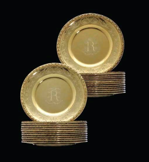 A SET OF TWENTY-FOUR SILVER-GILT DESSERT PLATES