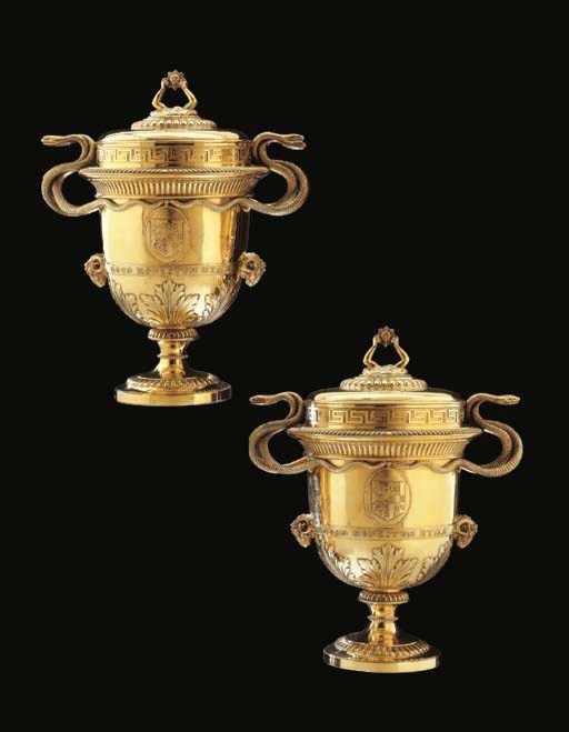 A PAIR OF GEORGE III SILVER-GILT CUPS AND COVERS
