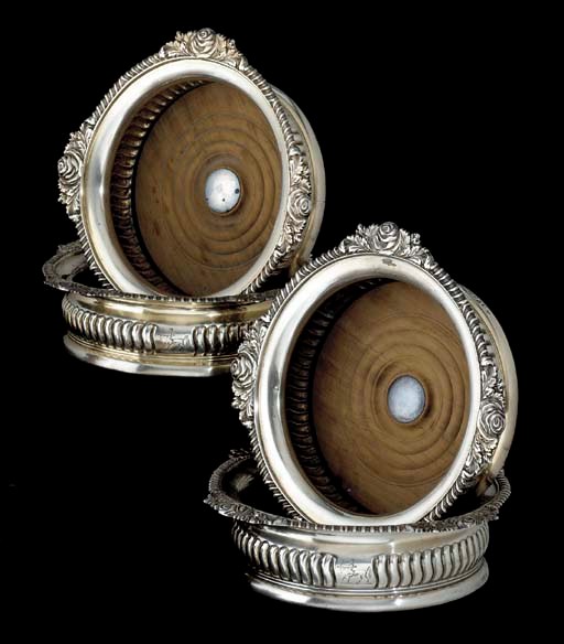 A SET OF FOUR REGENCY SILVER WINE COASTERS
