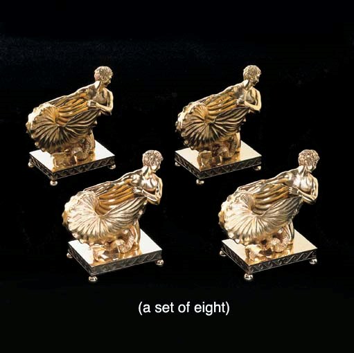 A SET OF EIGHT GEORGE III SILVER-GILT SALT CELLARS