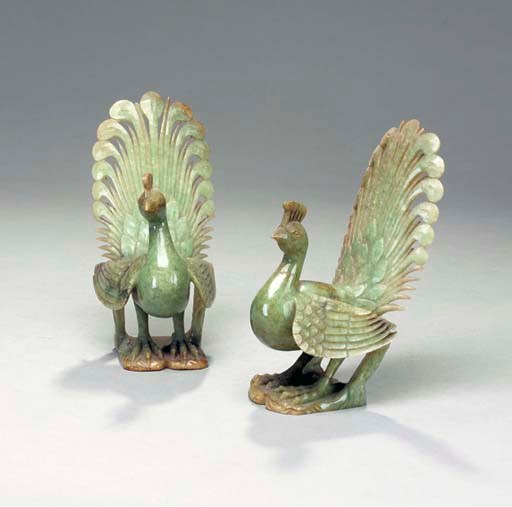 A PAIR OF MOTTLED RUSSET AND GREEN JADEITE FIGURES OF PEACOCKS,