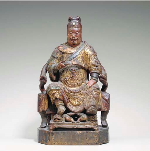 A LACQUERED AND GILT-WOOD FIGURE OF GUANDI,