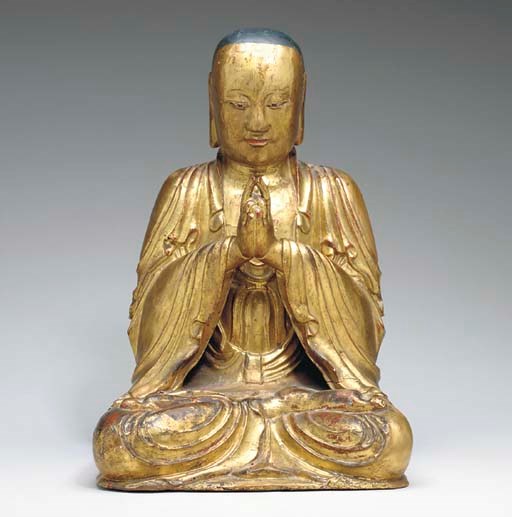 A GILT-WOOD AND LACQUERED FIGURE OF A SEATED BUDDHIST MONK,
