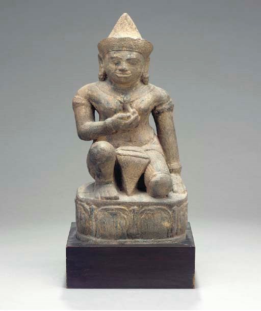 A CARVED STONE FIGURE OF A DEITY,
