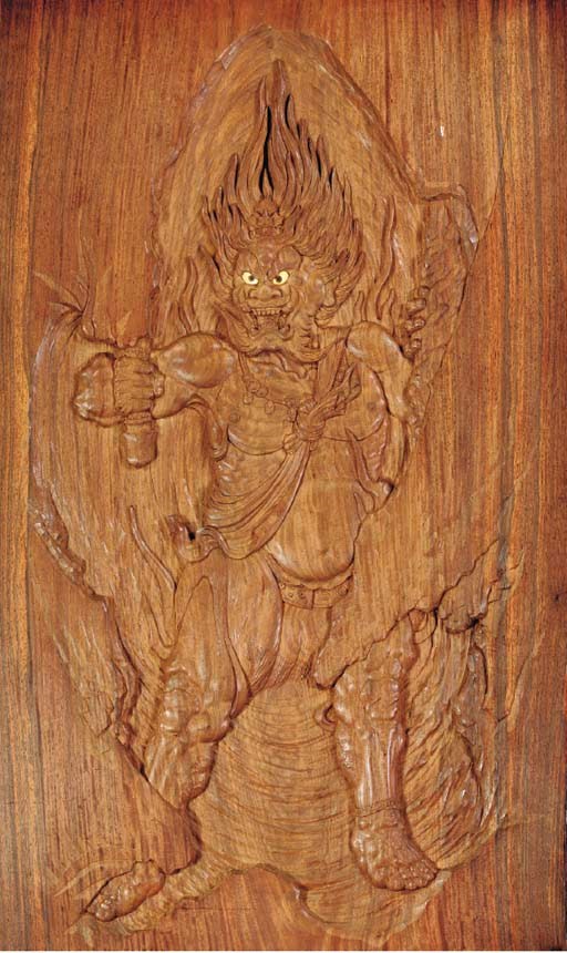 A CARVED AND LACQUERED WOOD PANEL