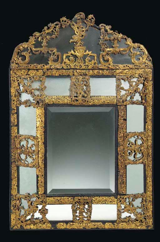 A DUTCH BAROQUE EBONIZED AND REPOUSEE BRASS MIRROR,
