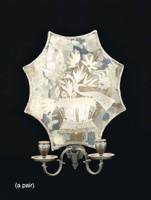 A PAIR OF SHAPED MIRRORED TWO LIGHT WALL LIGHTS,