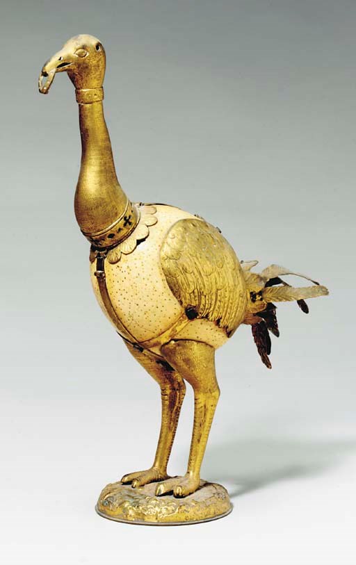 A BIRD-FORM GILT METAL MOUNTED OSTRICH EGG,