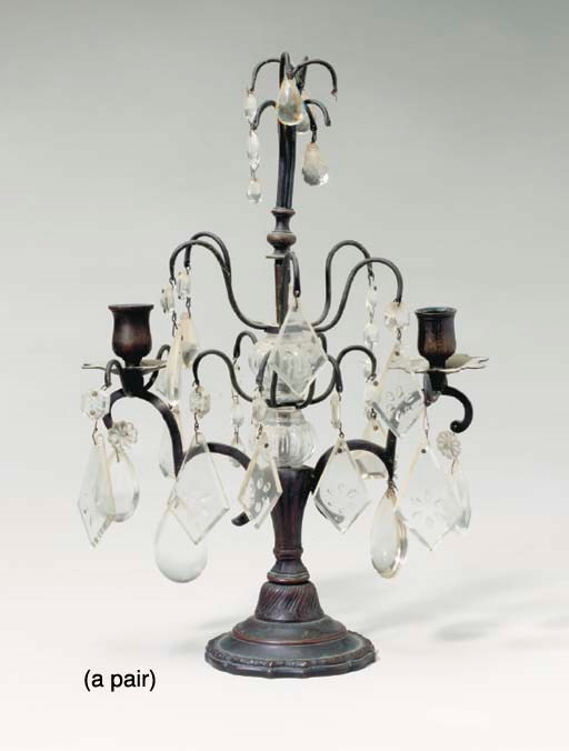 A PAIR OF PATINATED METAL AND CUT GLASS TWO LIGHT CANDELABRA